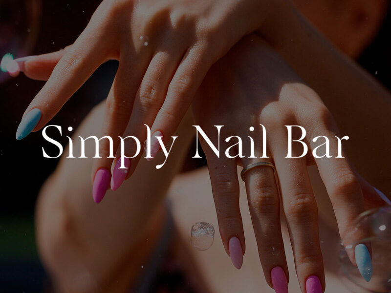 Simply Nail Bar logo over an image of a woman's hands crossed with colorful nails.